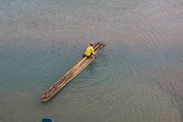 CLOSED FOR NOW A fisherman uses a bamboo raft to cross Abuan River in the remote village of Bintacan in the City of Ilagan, Isabela, on Jan. 14. The river, an ecotourism spot, has been ordered closed by the Ilagan City government to visitors for rehabilitation. —VILLAMOR VISAYA JR.