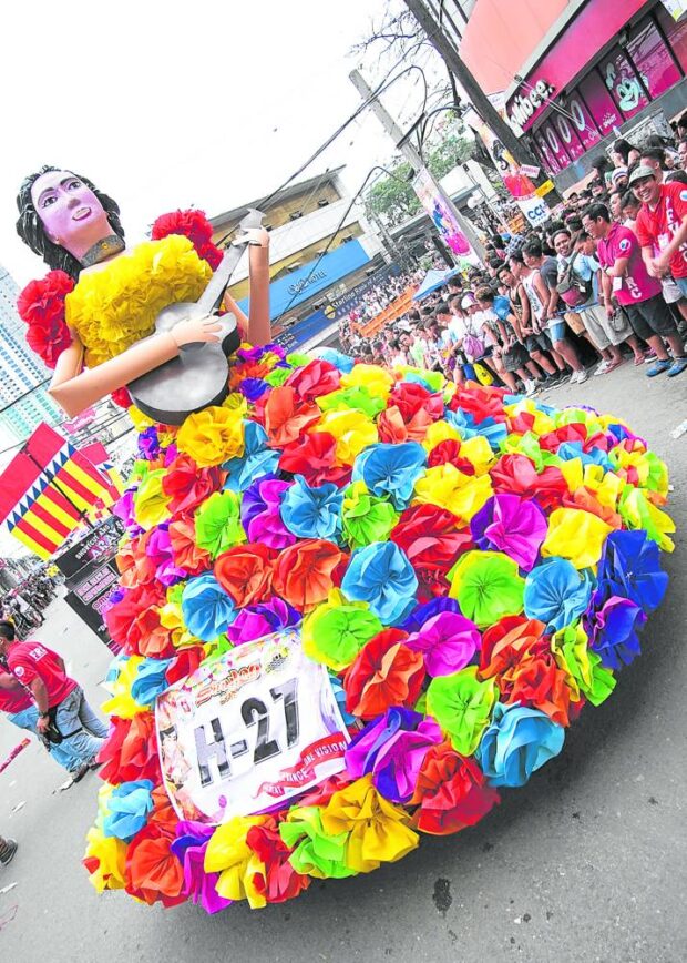 LOCAL PRODUCT One of the“higante” (giant) models in a previous staging of Sinulog Festival in Cebu City features a woman playing a guitar, one of the top products of the island of Cebu.