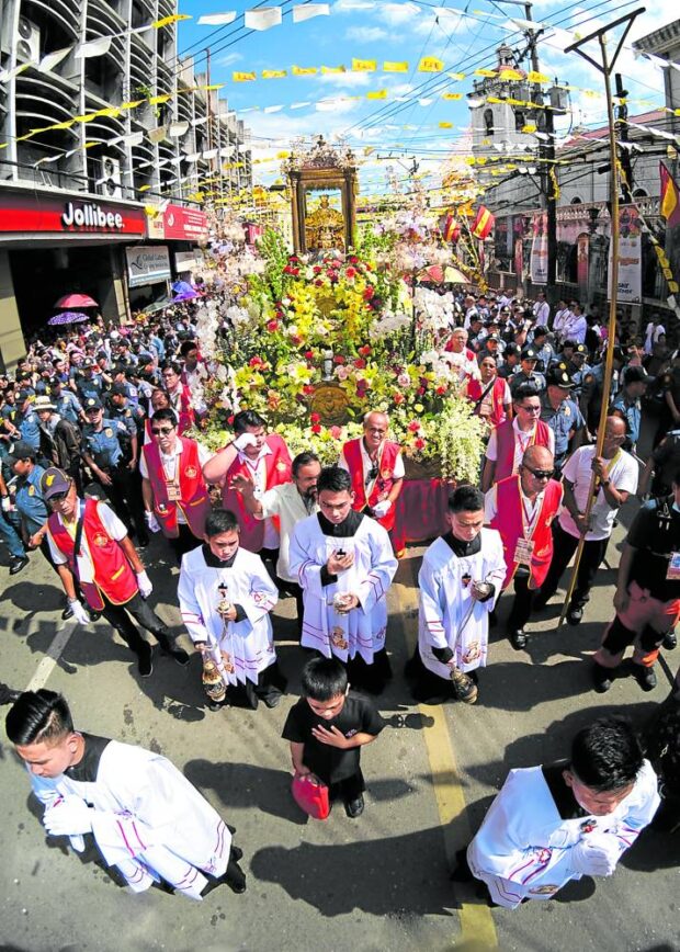Atcenter, people join the solemn procession of the Sto. Niño de Cebu on the eve of the feast of the Holy Child Jesus in 2020.
