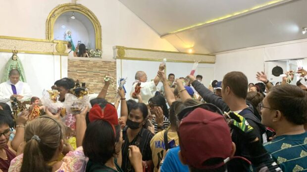 MOTHER OF THE LORD ROCK Devotees of the Blessed Virgin Mary hold deep reverence for the image of “Ina Poón Bato,” which they believe has healing power. In this photo taken on Sunday, the wooden image is venerated at the shrine run by the religious Iglesia Filipina Independiente or the Aglipayan church in Botolan, Zambales. —JOANNA ROSE AGLIBOT