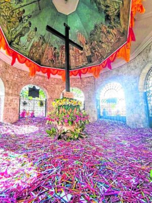  Unlighted candles pile up at Magellan’s Cross