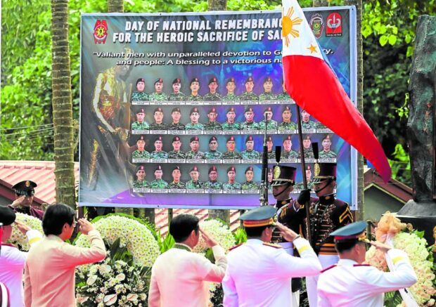 HONORING SLAIN COMMANDOS   President Marcos and other officials salute the 44 members of the elite Special Action Force who died nine years ago in a clandestine antiterrorist operation in Mamasapano, Maguindanao, in commemoration rites held on Thursday at the Philippine National Police Academy in Silang, Cavite. —PPA POOL