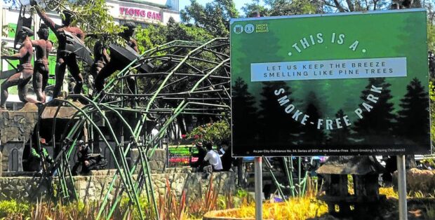SMELL THE PINE TREES, NOT CIGARETTES Playing on Baguio City's tourism brand, "Breathe Baguio," campaign boards at public places like the Igorot Park urge residents and tourists to "keep the breeze smelling like pine trees" by not smoking. The number of cigarette smokers has declined in the city due in part to strict regulations that ban tobacco use in public places. VINCENT CABREZA