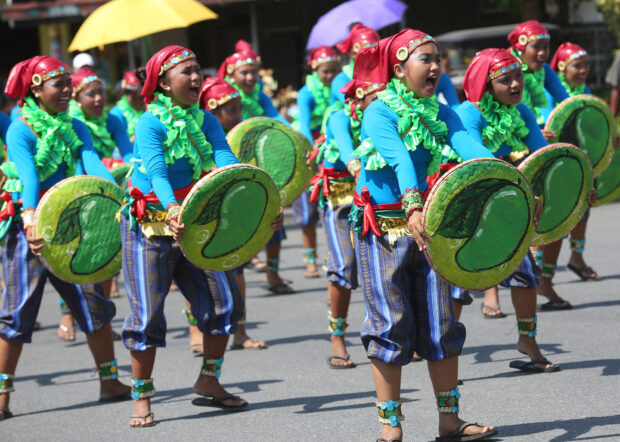 Participants adorned in costumes inspired by mangoes showcase their dance skills during the street dancing competition during one of the Dinamulag festivals in Zambales province to celebrate its abundant mango harvest.
