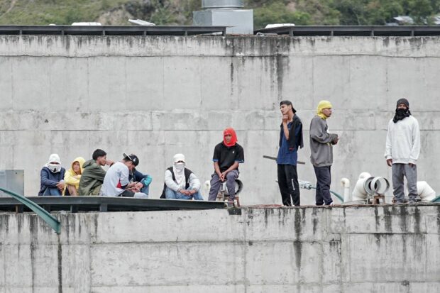 Inmates remain on the roof of the Turi prison, where prison guards are been held hostage, in Cuenca, Ecuador, on January 8, 2024.