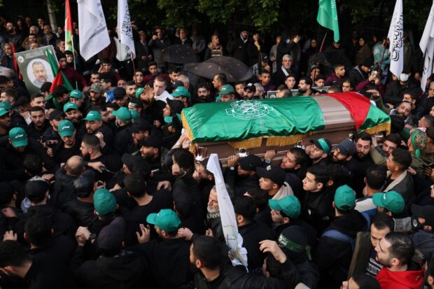 Mourners carry the coffin of Hamas' deputy leader, Saleh al-Aruri 