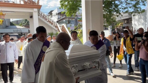 Priests carry the casket of Bishop Lunas into the Sto. Niño Cathedral in Pagadian City.