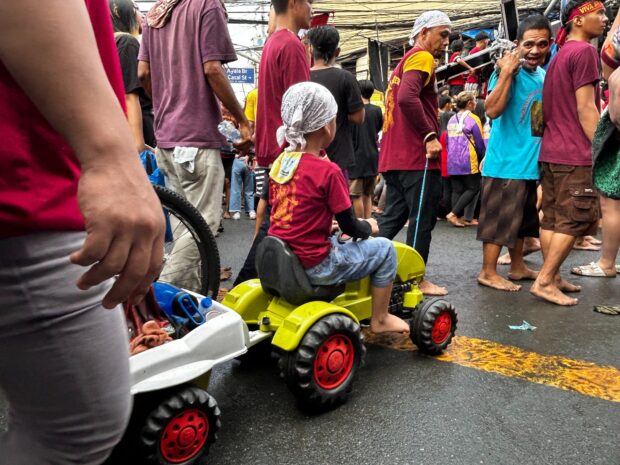 A child’s toy truck carries a replica image of the Black Nazarene. (Photo by Zeus Legaspi)