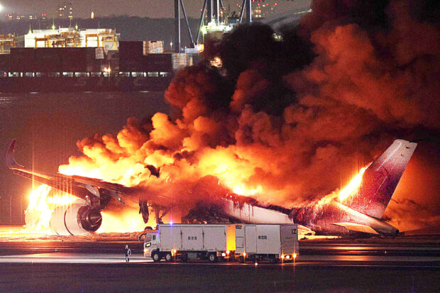 JAL plane on fire on runway at Tokyo's Haneda airport