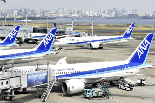 All Nippon Airways (ANA) airplanes are seen at Haneda airport in Tokyo on March 31, 2022. An All Nippon Airways domestic flight turned back to Japan’s northern airport of Sapporo on Saturday, Jan. 13, 2024, after a crack was found on the cockpit window, according to the airline and media reports.