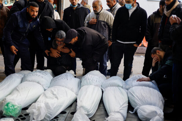 Mourners react next to the bodies of Palestinians killed in an Israeli strike, in Rafah