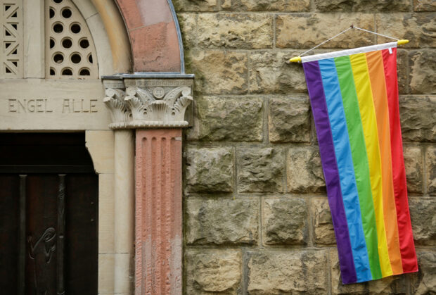 FILE PHOTO: A rainbow flag is seen on the wall of a Catholic church in Cologne