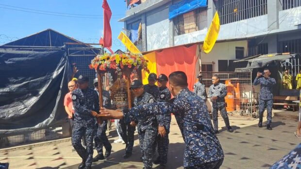 Jail guards carry the glass case that contains the image of the Sto. Niño de Cebu. (DALE ISRAEL / INQUIRER VISAYAS)