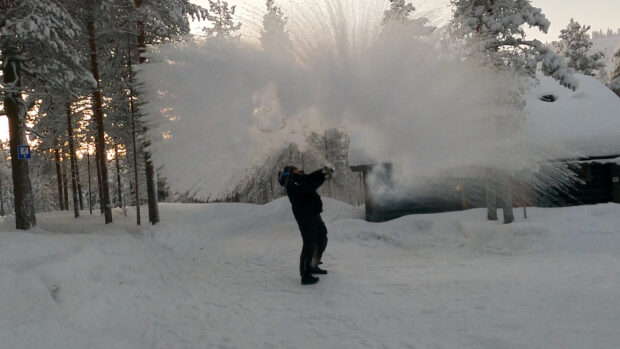 A person throws boiling water into the air, following cold weather, in Pyhatunturi