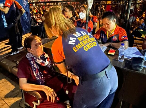 A senior citizen is brought to the MMDA medic tent at Quirino Grandstand after experiencing hypertension symptoms. John Eric Mendoza/INQUIRER.net