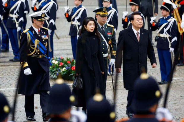 South Korea's President Yoon Suk Yeol and his wife Kim Keon Hee walk during a ceremony in Amsterdam, Netherlands December 12, 2023. 