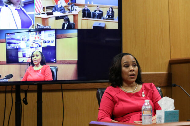 Attorney Fani Willis speaks from a witness stand during a hearing in the case of State of Georgia v. Donald John Trump at the Fulton County Courthouse in Atlanta, Georgia