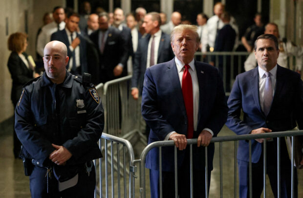 Former U.S. President Donald Trump speaks outside the courtroom on the day of a court hearing on charges of falsifying business records to cover up a hush money payment to a porn star before the 2016 election, in New York State Supreme Court in the Manhattan borough of New York City, U.S., February 15, 2024. REUTERS/Andrew Kelly/File Photo