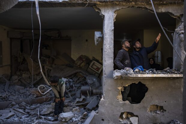 PHOTO: Palestinians look at the destruction after an Israeli strike in Rafah, southern Gaza Strip, Thursday, Feb. 8, 2024. STORY: 