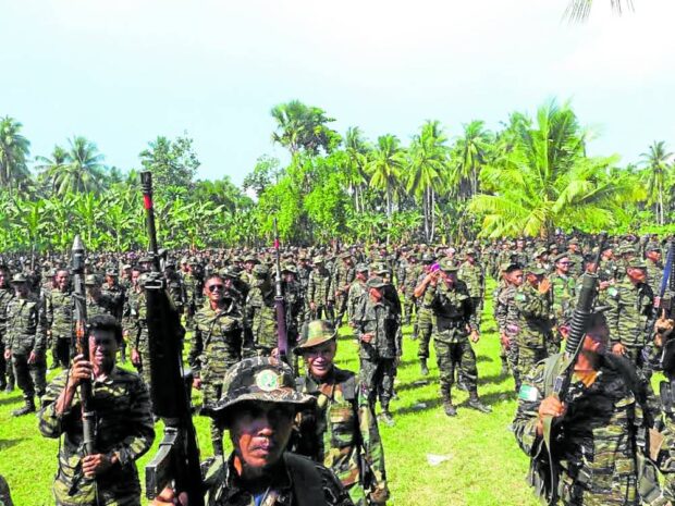 FIRE POWER Moro Islamic Liberation Front fighters brandish their high-powered weapons at Camp Darapanan in Sultan Kudarat town of the then undivided Maguindanao province in this undated photo, taken prior to start of the decommissioning of MILF members and their firearms in 2019. BONG S. SARMIENTO