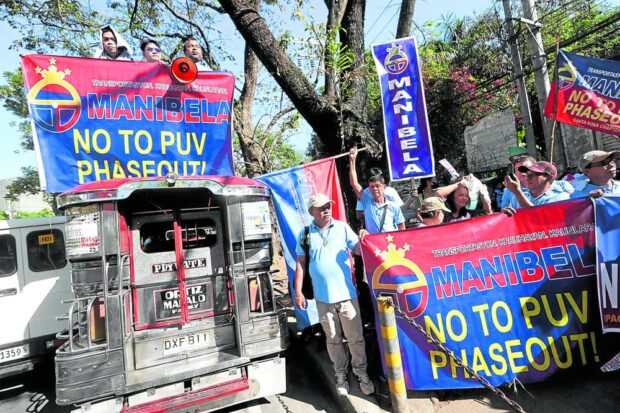 PHOTO: Members of transport group Manibela hold a rally in front of the Office of the Ombudsman where they filed on Wednesday, Feb. 7, 2024, a criminal complaints against several government officials. STORY: Transport group sues gov’t execs over PUV modernization program