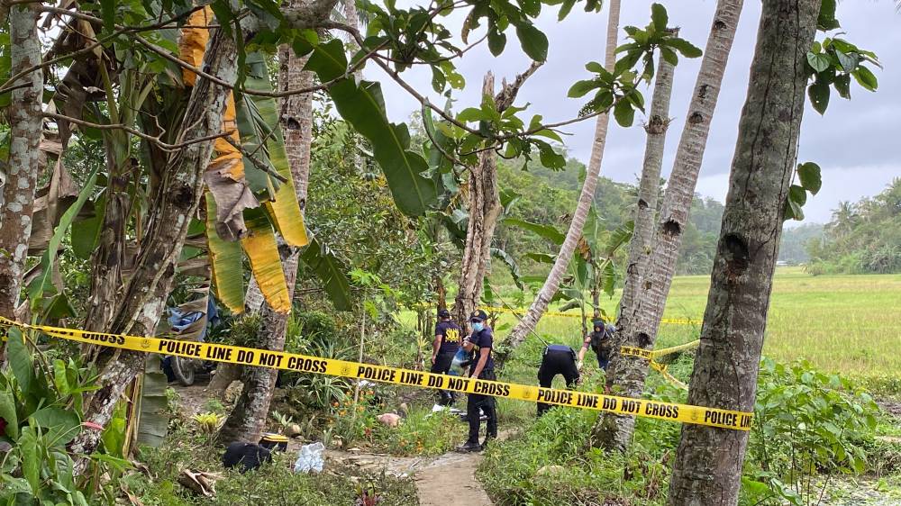 Investigators seal off an area near a rice field in the village of Campagao in Bilar, Bohol, where a New People’s Army rebel died in a shootout with pursuing policemen and soldierson Friday.
