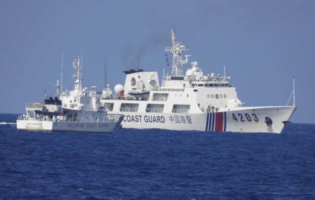 ‘DANGEROUSLY CLOSE’ In this June 2023 photo, a China Coast Guard vessel maneuvers “dangerously close” to a smaller Philippine Coast Guard ship supporting a resupply mission in Ayungin (Second Thomas) Shoal in the West Philippine Sea. —PHOTO COURTESY OF PHILIPPINE COAST GUARD