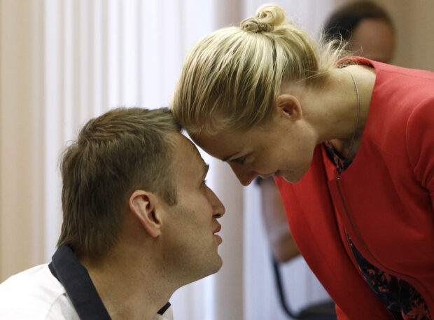 Russian opposition leader and anti-corruption blogger Alexei Navalny and his wife Yulia speak during a break in a court hearing in Kirov