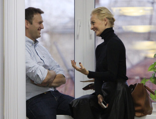 Russian opposition leader Alexei Navalny speaks with his wife Yulia during a break in a court session in Kirov