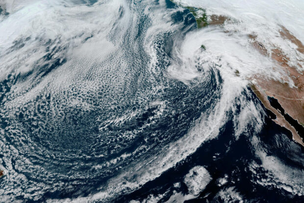 Heavy cloud system moves towards the U.S. west coast in a composite image from the NOAA GOES-West weather satellite