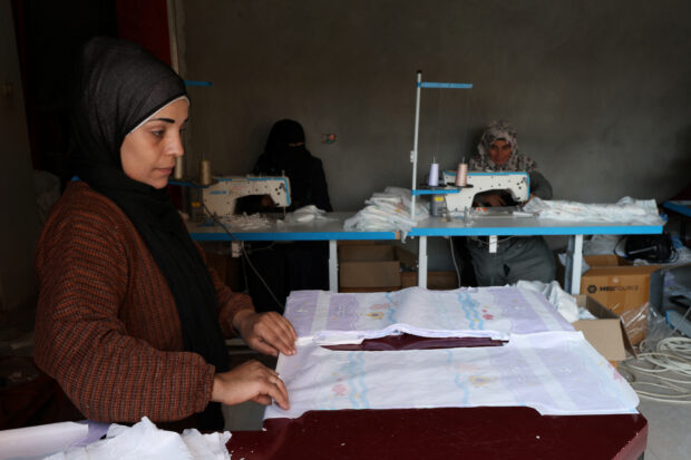 Palestinians sew diapers in a workshop amid scarcity as the conflict between Israel and Hamas continues, in Rafah