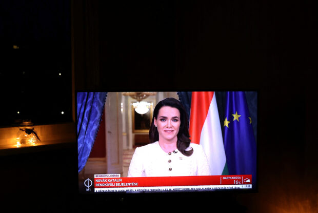 A screen shows the Hungarian President Novak as she announces her resignation after granting pardon in sex abuse case in Budapest