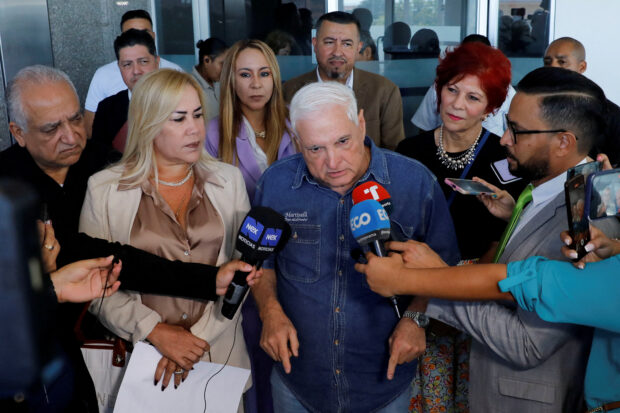 Panama's former President Ricardo Martinelli addresses the media while leaving the National Assembly, in Panama City