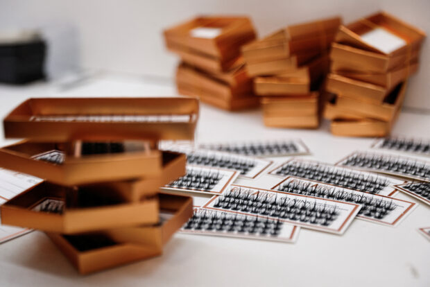 Packs of false eyelashes are pictured on a table at a workshop of Monsheery, in Pingdu