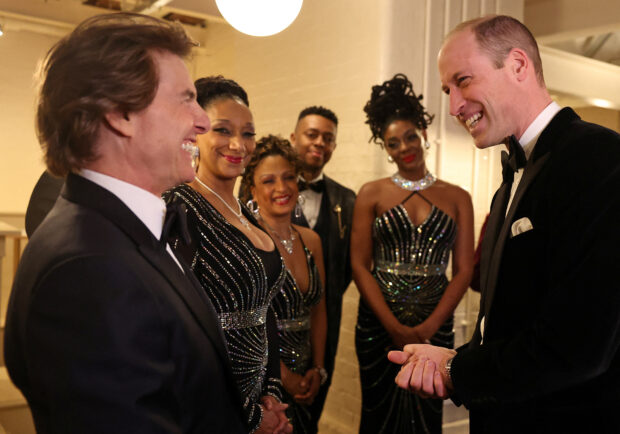 Britain's Prince William, Prince of Wales, reacts as he talks with U.S. actor Tom Cruise