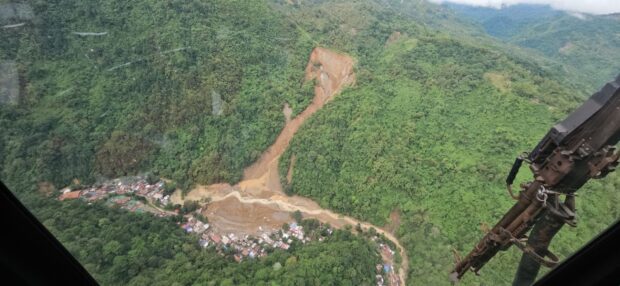 WHERE TRAGEDY STRUCK This aerial shot of the landslide that hit Barangay Masara in Maco, Davao de Oro, was taken on Feb. 8, two days after the massive soil erosion buried vehicles and houses and killed at least 98 people. Photo was taken aboard a helicopter of the Philippine Air Force Tactical Operations Wing Eastern Mindanao. —OFFICE OF CIVIL DEFENSE DAVAO REGION