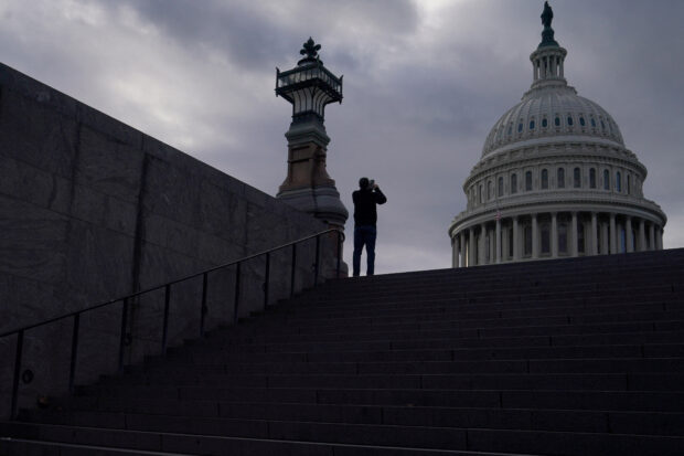 A man uses his mobile phone near the U.S. Capitol in Washington