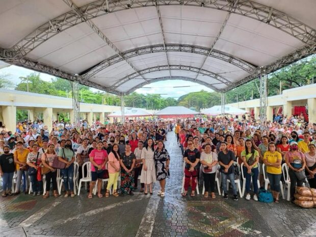 In this undated photo provided by the Quezon City government, Mayor Joy Belmonte hands out cash assistance to 675 recipient4s of PangkabuhayanQC package.