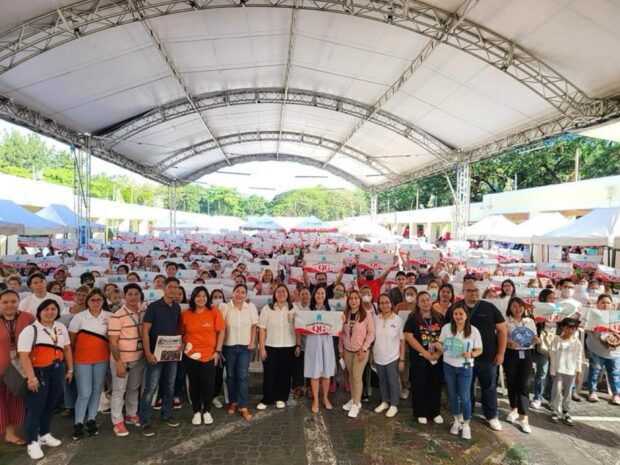 In this undated photo provided by the Quezon City government, Mayor Joy Belmonte distributes cash assistance to 1,314 small business owners under the SIGA program.