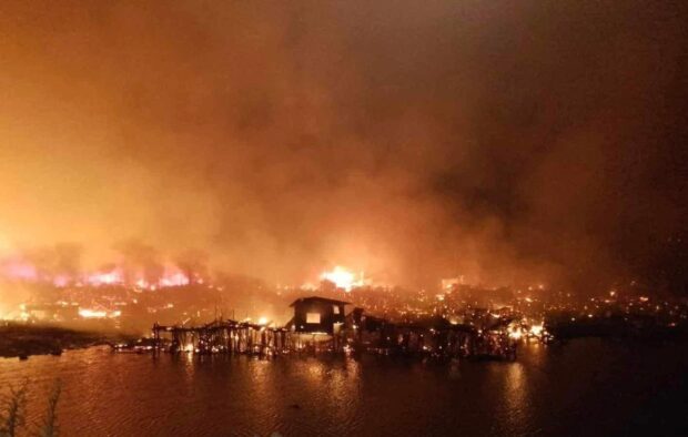 PHOTO: Panoramic view of a massive fire early morning of February 7, 2024 leaves over 450 households in Puerto Princesa’s Barangay Pagkakaisa and Barangay Bagong Silang razed. STORY: Palawan fire victims to receive P35 million aid