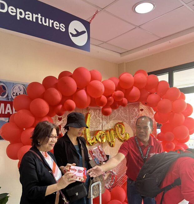 STORY: CAAP greets travelers with flowers, chocolates on Valentine's Day