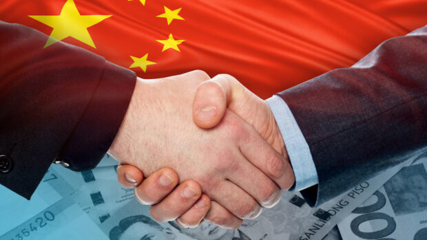 PHOTO: Composite image of handshaking with China flag and peso bills in the background STORY: WPS economic sanctions to hurt PH, but China even more