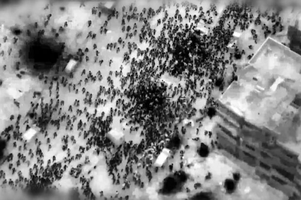 This image grab from a handout video released by the Israeli army on February 29, 2024, shows what the army says are Gazans around aid trucks in Gaza City. Israeli forces shot dead 104 people when a crowd rushed towards aid trucks on February 29, the health ministry in Hamas-run Gaza said. Israeli sources confirmed that troops opened fire at Palestinians rushing toward aid trucks in Gaza, with one saying soldiers thought they "posed a threat" to troops. 