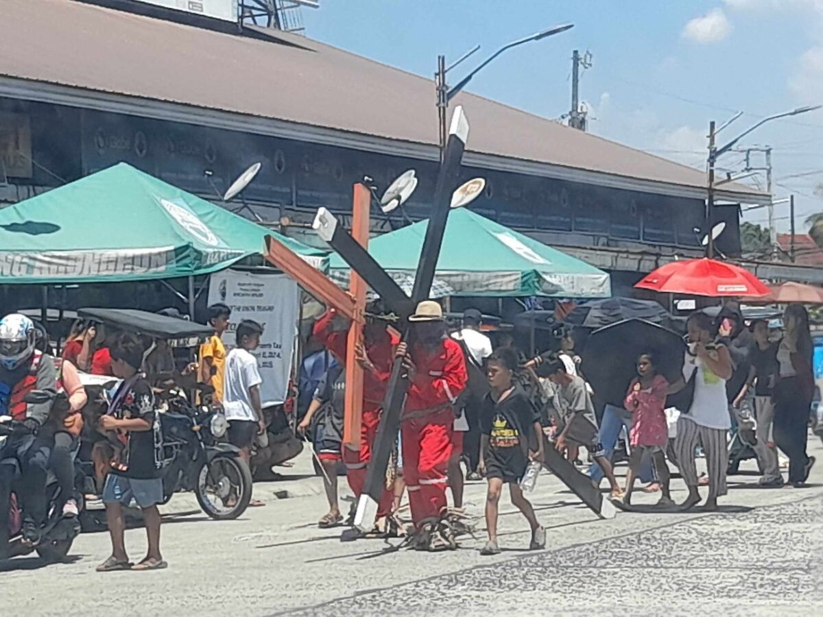 PHOTO: Penitents carry wooden crosses to reenact the passion of Christ on Good Friday, March 29, 2024, in Castillejos, Zambales. STORY: 'Senakulo' staged in Zambales town on Good Friday