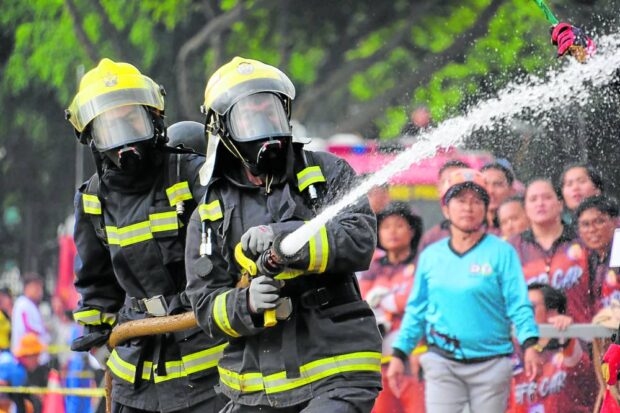 THE GAMES Firefighters from across the country converge at Burnham Park in Baguio City on Tuesday to take part in the 8th National Fire Olympics that simulated rescue operations and putting out fires. —NEIL CLARK ONGCHANGCO