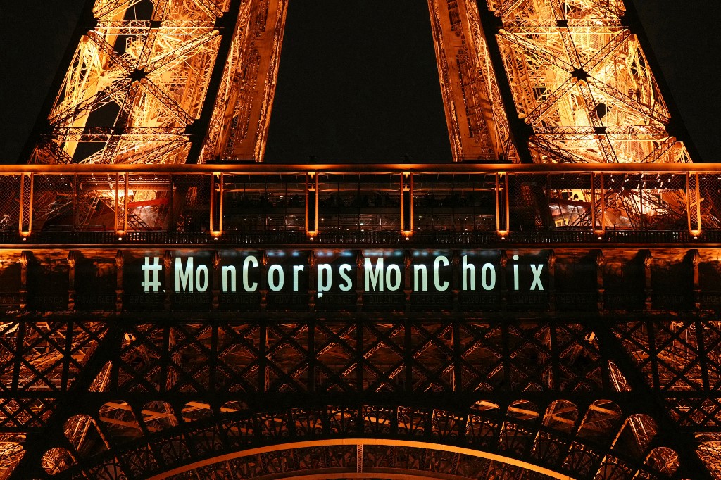 A message reading "My body my choice" is projected onto the Eiffel Tower 