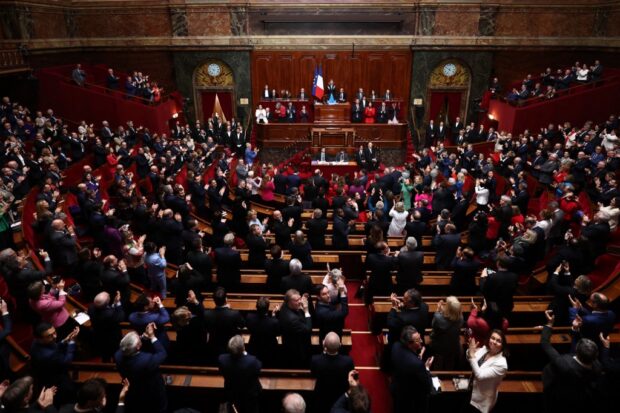 Deputados e senadores aplaudem depois que o parlamento francês votou pela consagração do direito ao aborto na constituição do país, 