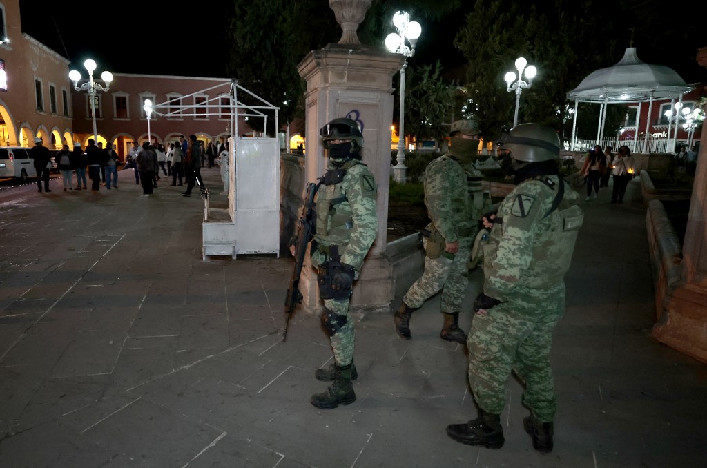 Mexican army soldiers patrol near a rally 