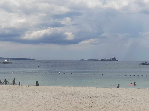 A few residents of Olongapo City are seeking respite from the scorching sun by cooling off the beach in this photo taken on Wednesday, March 27, as the heat index is feared to reach the dangerous level. 