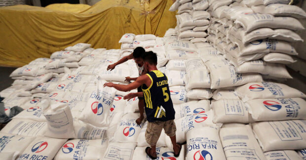 PHOTO: Workers stack rice at a warehouse of National Food Authority. STORY: Tougher oversight on NFA rice stocks sought
